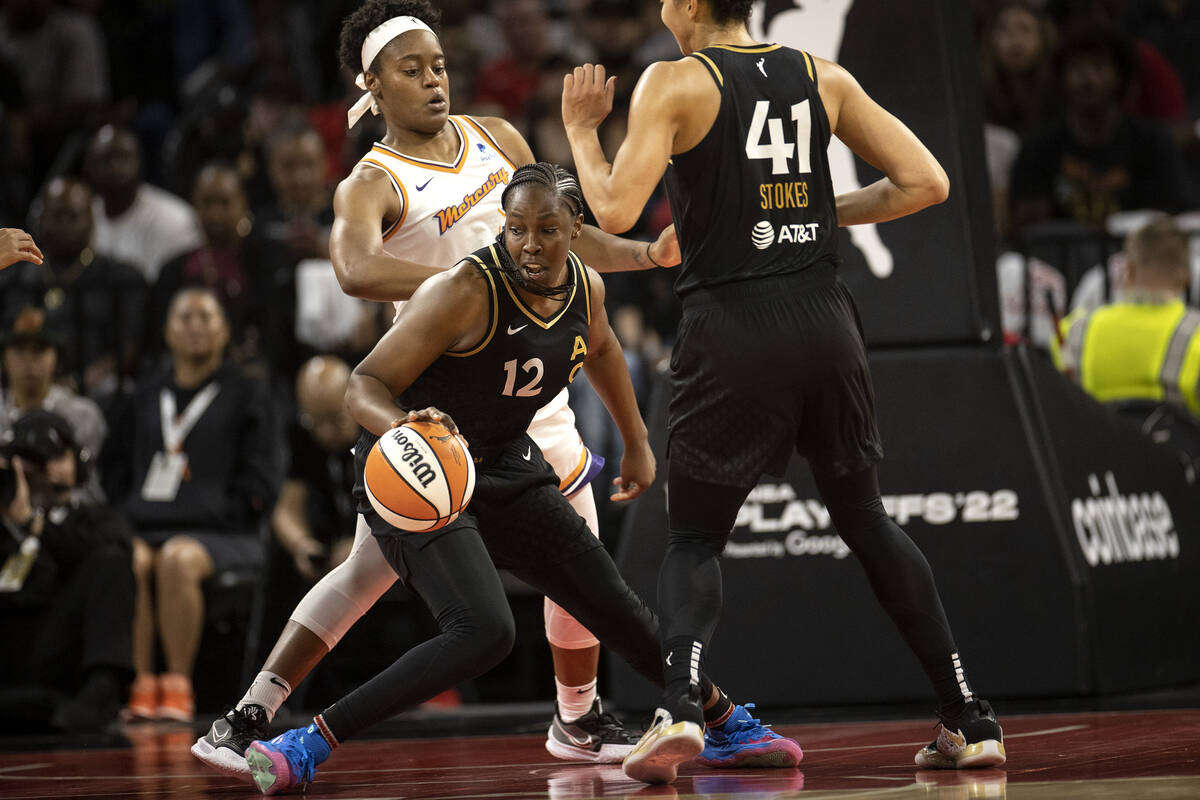 Las Vegas Aces guard Chelsea Gray (12) dribbles around Phoenix Mercury guard Kaela Davis (3) du ...