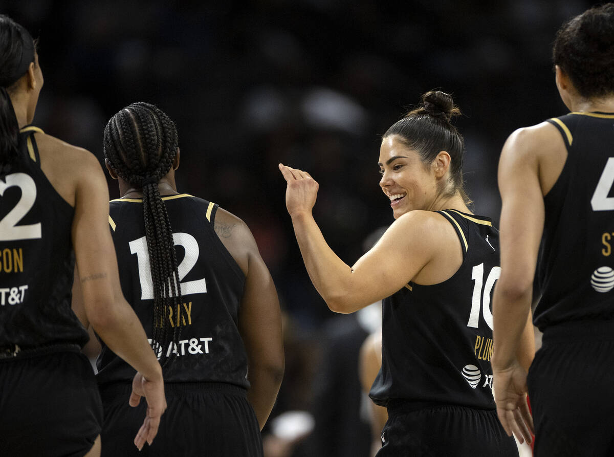 Las Vegas Aces guard Kelsey Plum (10) slaps hands with guard Chelsea Gray (12) during the secon ...