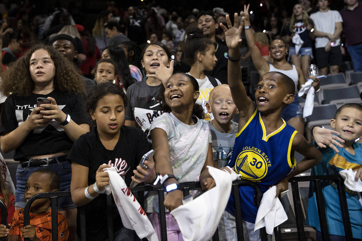Young Las Vegas Aces cheer for their team after they won a WNBA playoff basketball game against ...