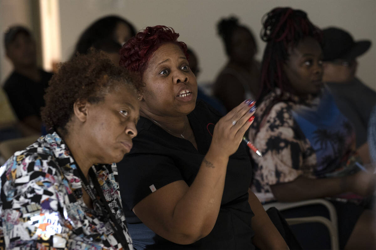Ursulia Christmas, center, asks questions about the potential relocation of her family during a ...