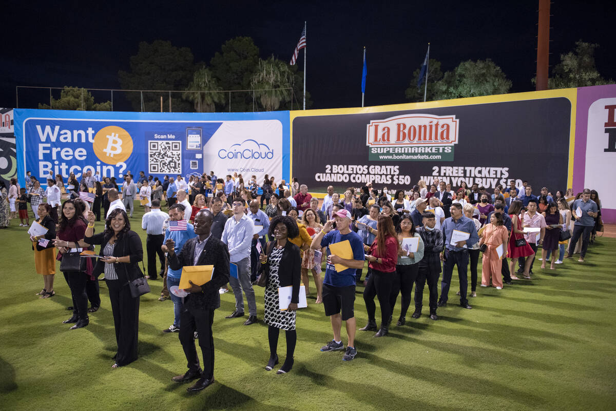 About 700 people become U.S. citizens during a naturalization ceremony at halftime of the Las V ...