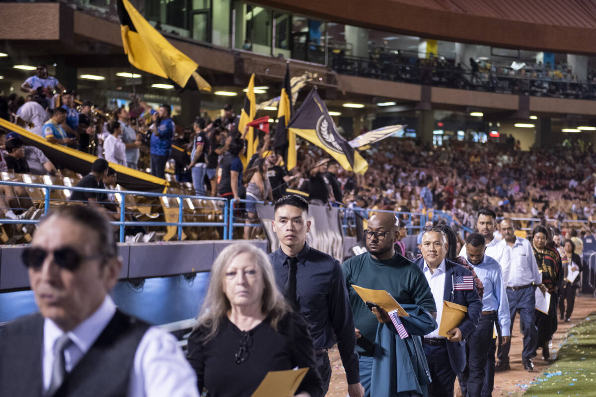About 700 people become U.S. citizens during a naturalization ceremony at halftime of the Las V ...