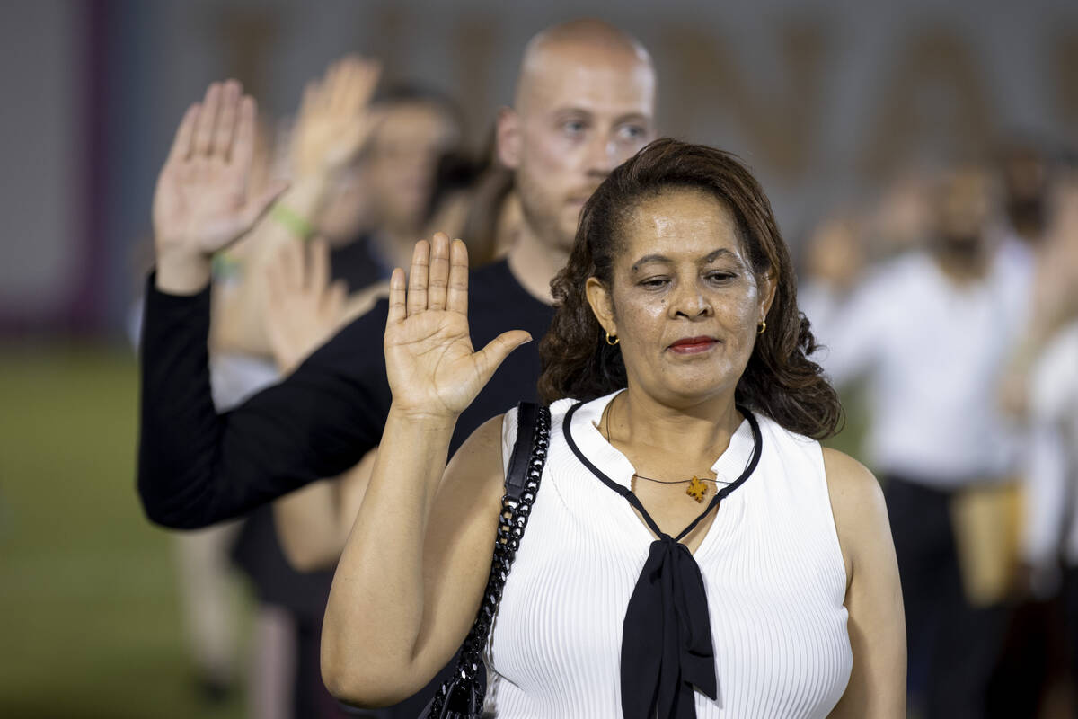 Yodit Abebe, originally from Ethiopia, takes the naturalization oath during a naturalization ce ...