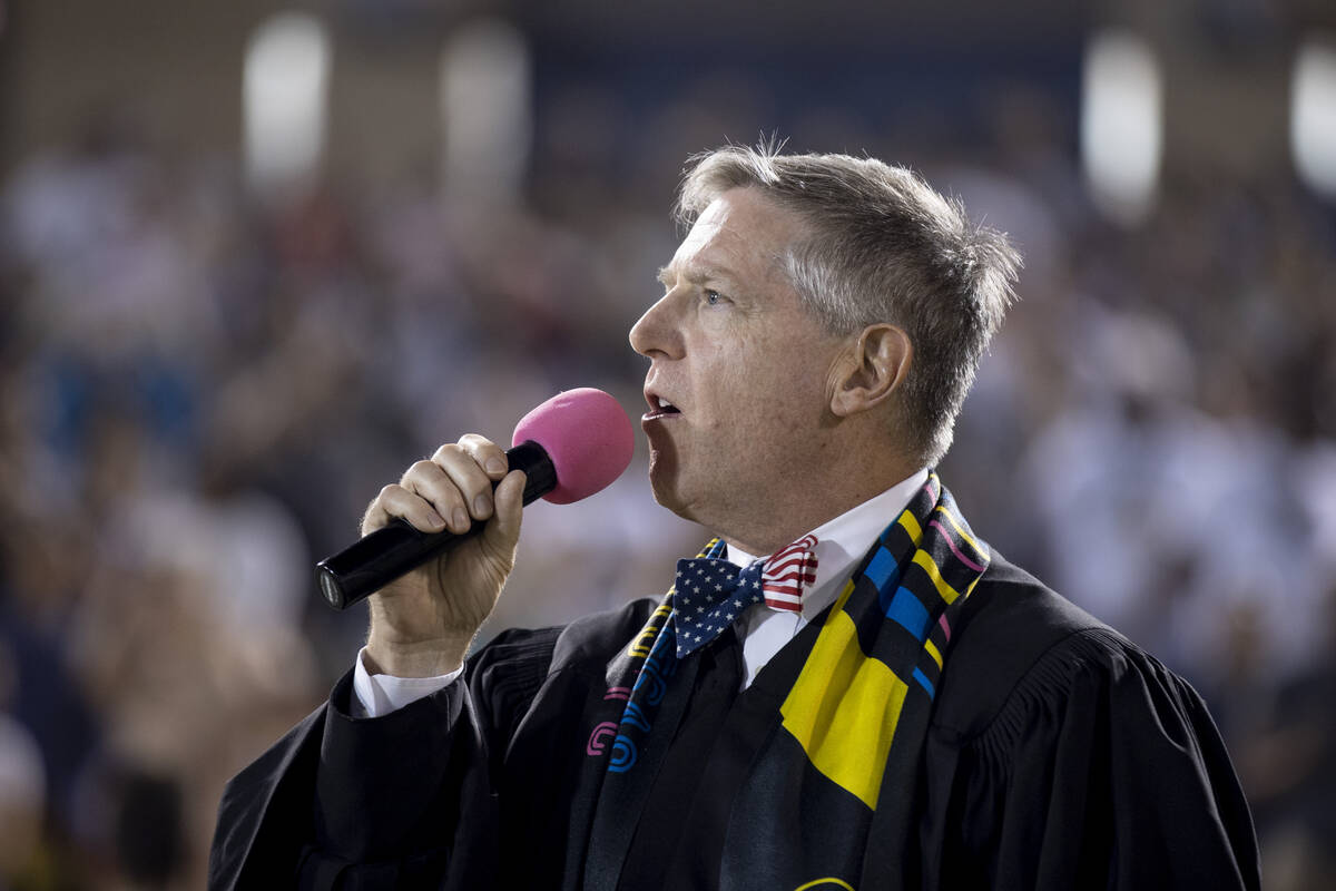 Judge Andrew Gordon performs a naturalization ceremony for about 700 new U.S. citizens at halft ...