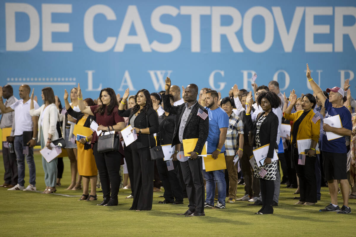 About 700 people become U.S. citizens during a naturalization ceremony at halftime of the Las V ...