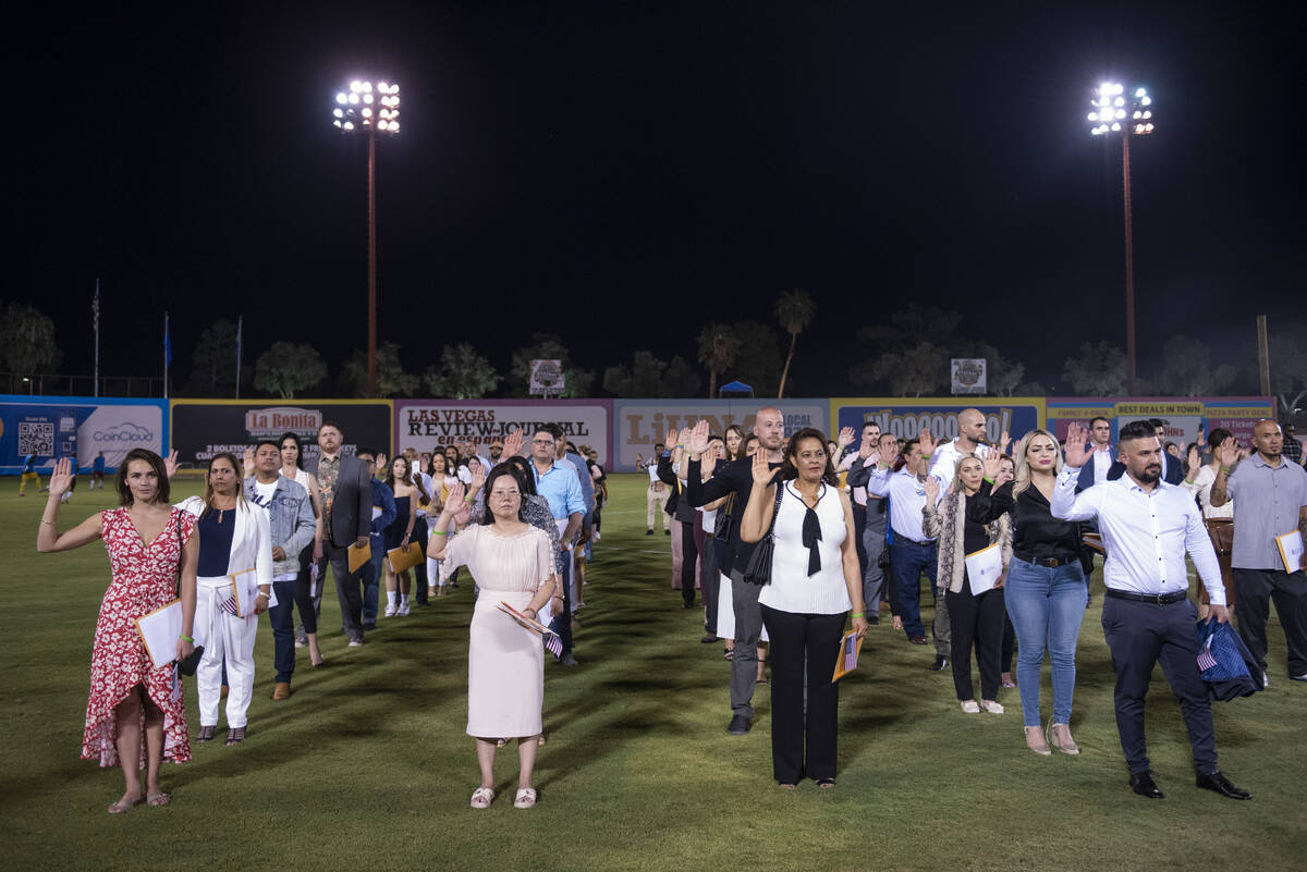 About 700 people become U.S. citizens during a naturalization ceremony at halftime of the Las V ...