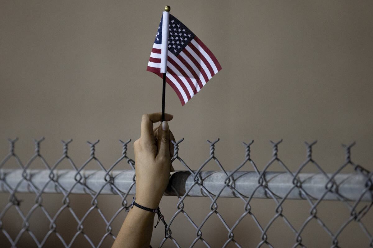 About 700 people become U.S. citizens during a naturalization ceremony at halftime of the Las V ...