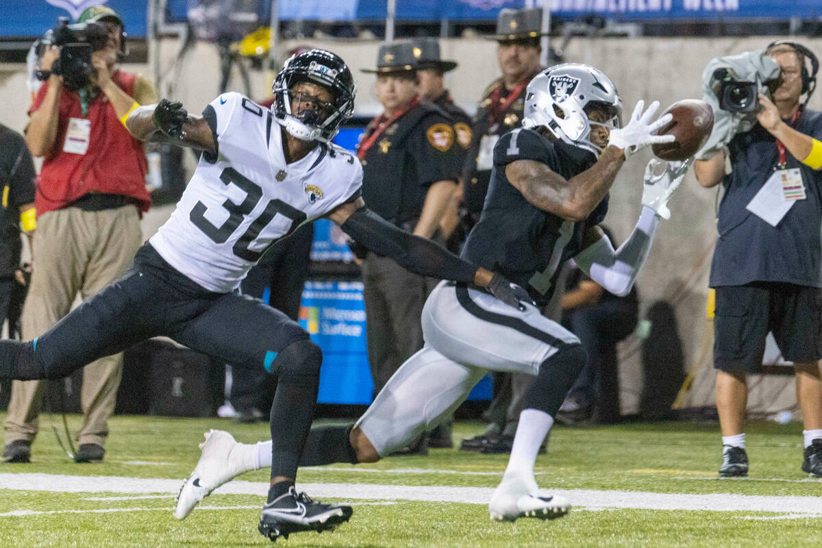 Raiders wide receiver Tyron Johnson (1) tries to haul in a pass as Jacksonville Jaguars cornerb ...