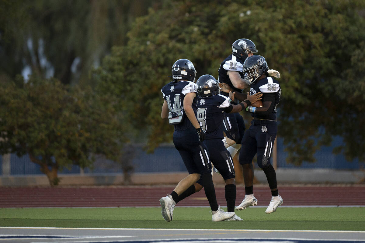 Shadow Ridge wide receiver Liam Guthrie (14), quarterback Coen Coloma (8) and running back Davi ...
