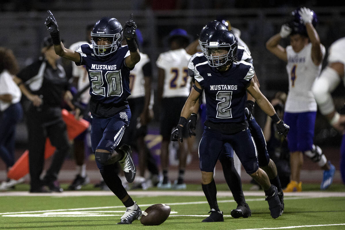 Shadow Ridge corner back Miah Campbell (20) and safety Kela Cox (2) celebrate after Campbell ca ...