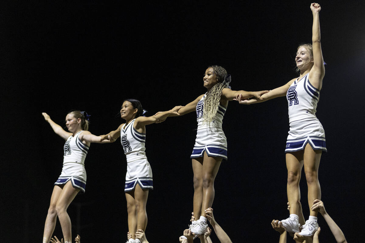 Shadow Ridge cheerleaders do a stunt after their team scored a touchdown during a Class 4A high ...