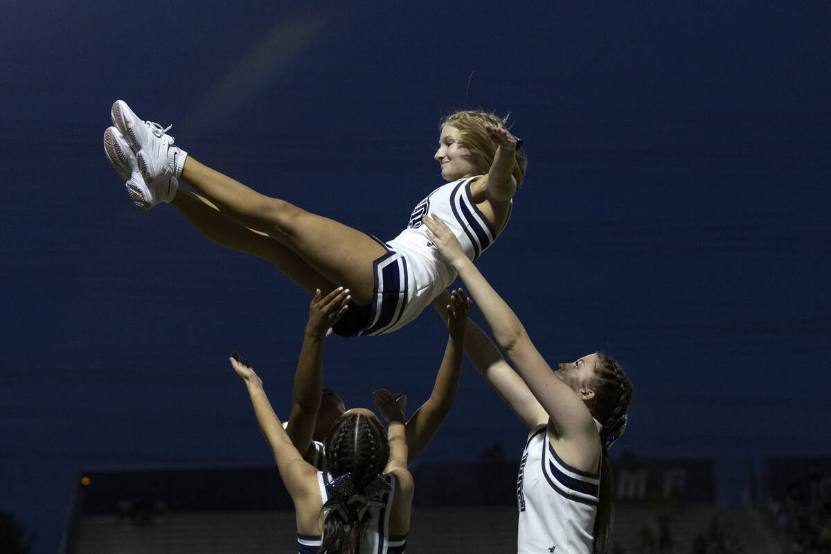 Shadow Ridge cheerleaders do a stunt after their team scored a touchdown during a Class 4A high ...