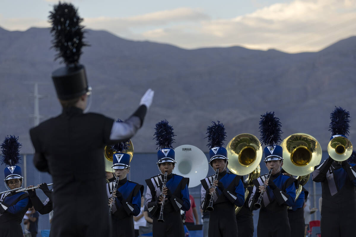 The Shadow Ridge marching band plays the National Anthem before a Class 4A high school football ...
