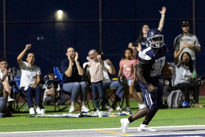 Shadow Ridge slotback Jon Wilson (32) celebrates after scoring a touchdown during a Class 4A hi ...