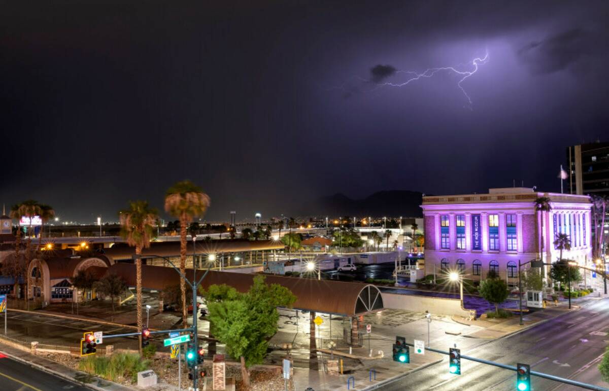 Lightning is seen behind The Mob Museum as thunderstorms move across the Las Vegas Valley on Fr ...
