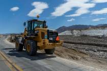 Construction machinery continues to clear State Route 190 of mud flows within Death Valley Nati ...