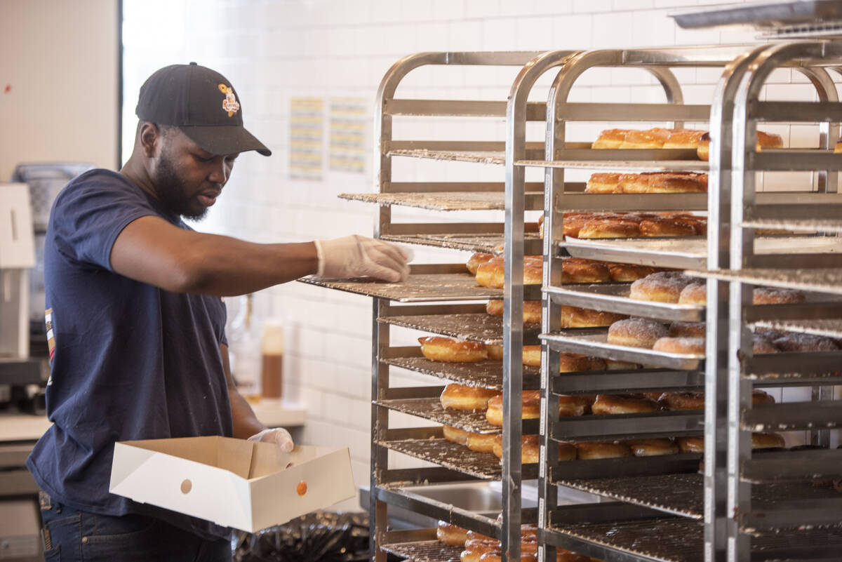 Daniel Ramadji packs a box for a customer at Randy's Donuts on South Rainbow Boulevard on Frida ...