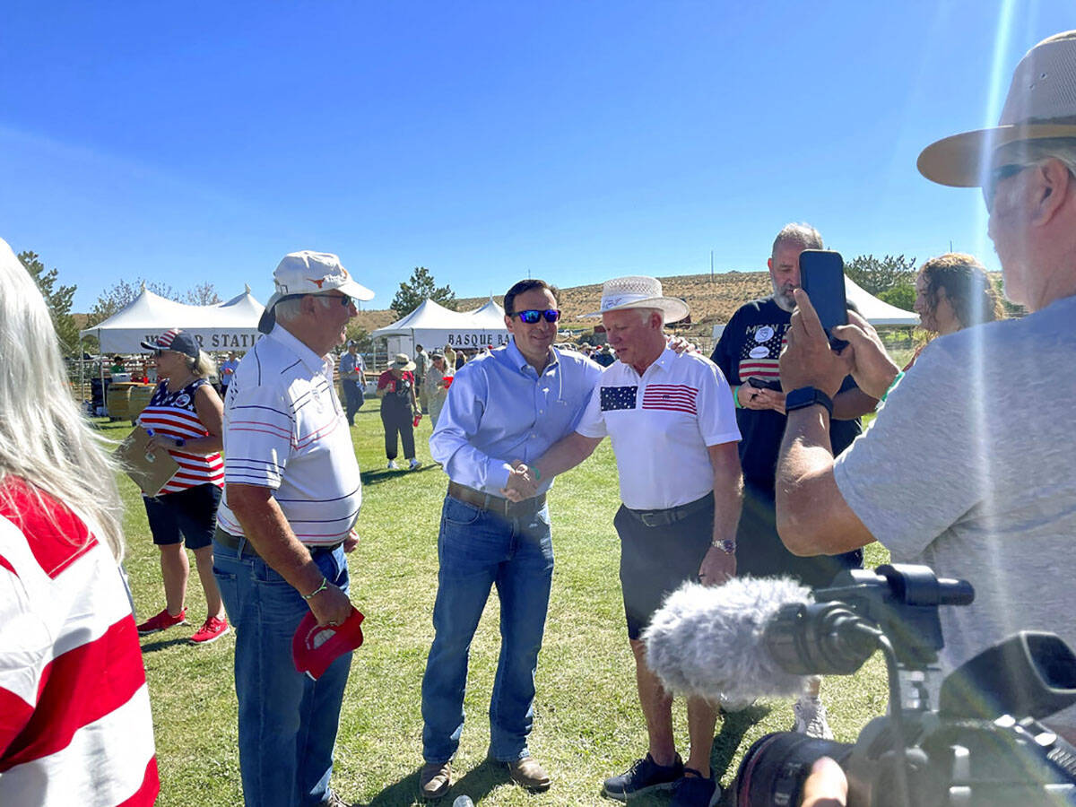 Republican U.S. Senate nominee Adam Laxalt, center left, takes pictures with supporters at the ...