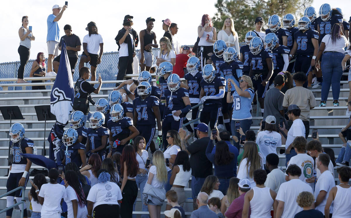 Centennial High School players enter the field before a football game against Silverado High Sc ...