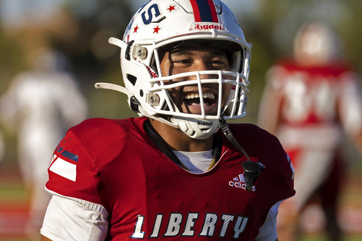 Liberty running back Isaiah Lauofo (3) celebrates after scoring a touchdown during a Class 5A h ...