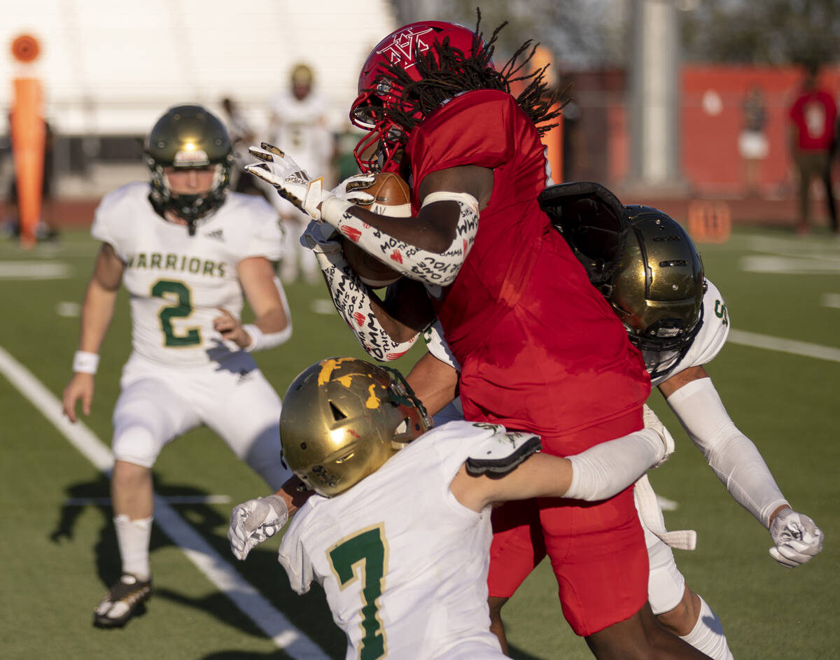 Snow Canyon's Brandon Gough (7) and Kolter Stuart (8) tackle Arbor View's David Washington (18) ...