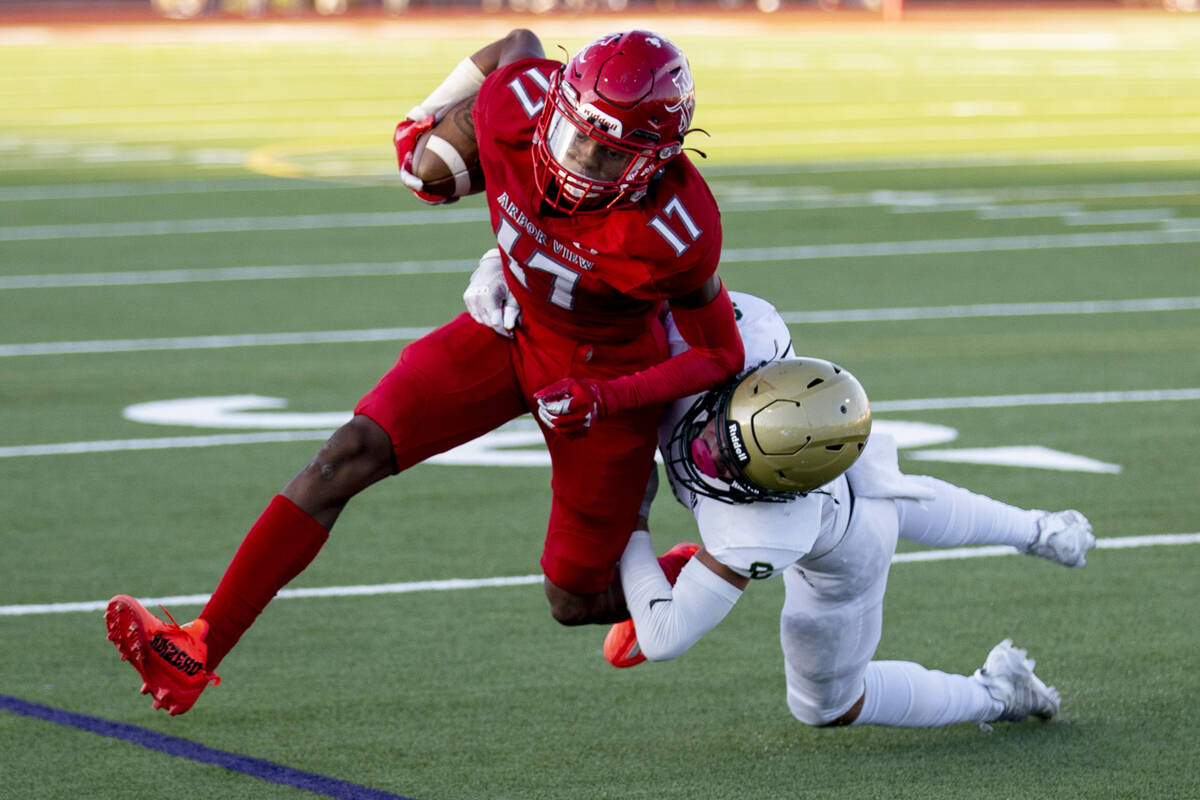 Snow Canyon's Makaio Swensen (5) tackles Arbor View's Amari Derby (17) during the first game of ...