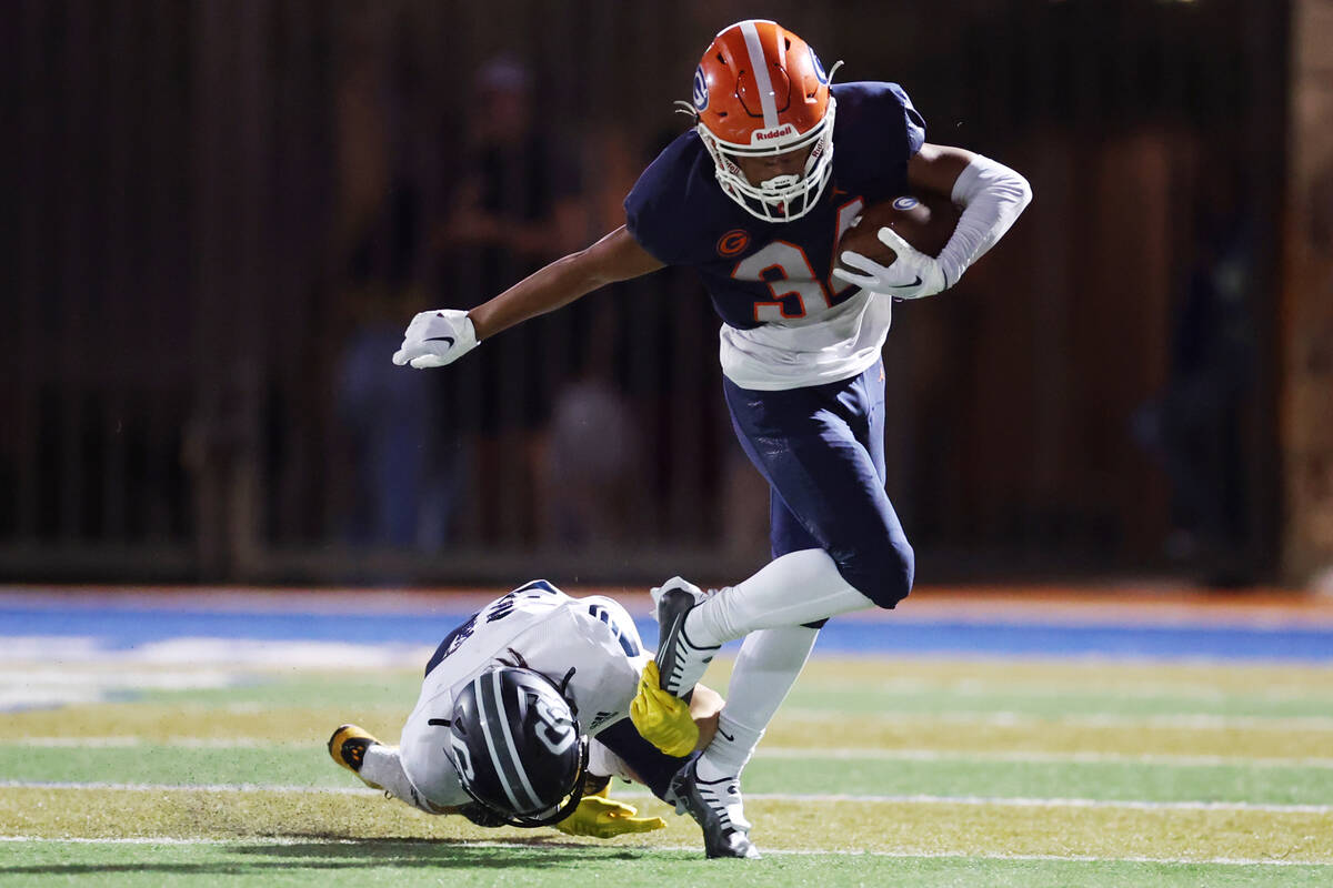 Bishop Gorman's Myles Norman (34) evades a tackle by a Corner Canyon player during the second h ...