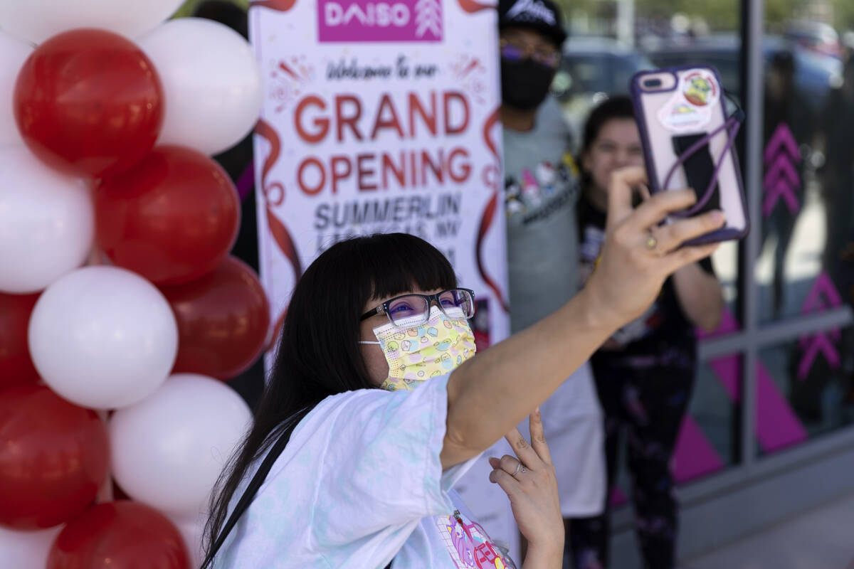 Mika Garcia of Las Vegas takes a photo outside of the newly opened Daiso store during the grand ...