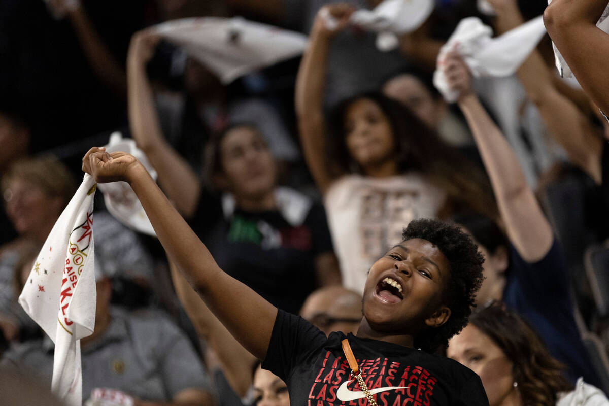 A Las Vegas Aces fan waves their towel during the second half of a WNBA playoff basketball game ...