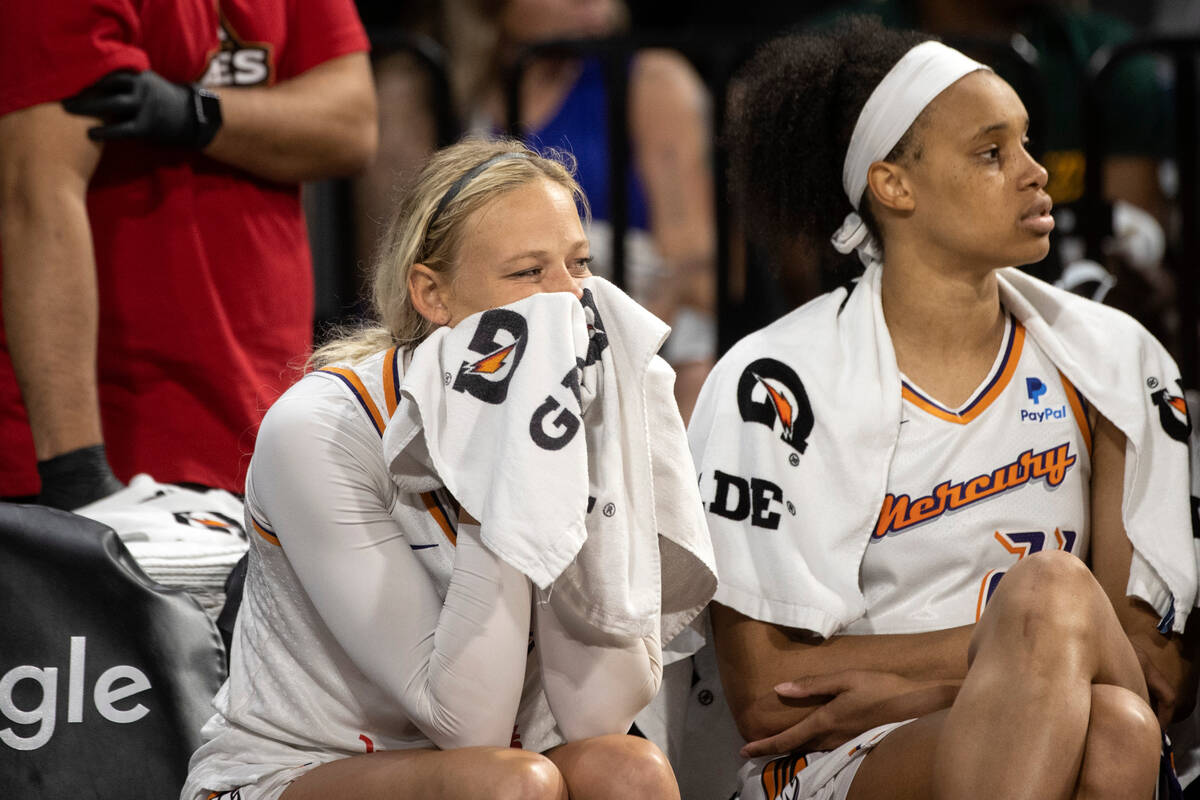 Phoenix Mercury guard Sophie Cunningham (9) covers her face with a towel next to forward Briann ...