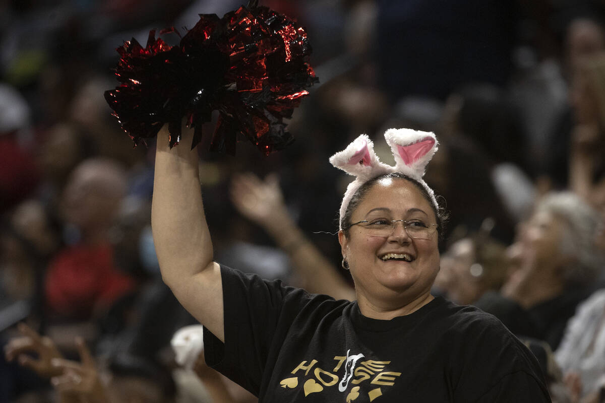 A Las Vegas Aces fan cheers from the crown during the second half of a WNBA playoff basketball ...