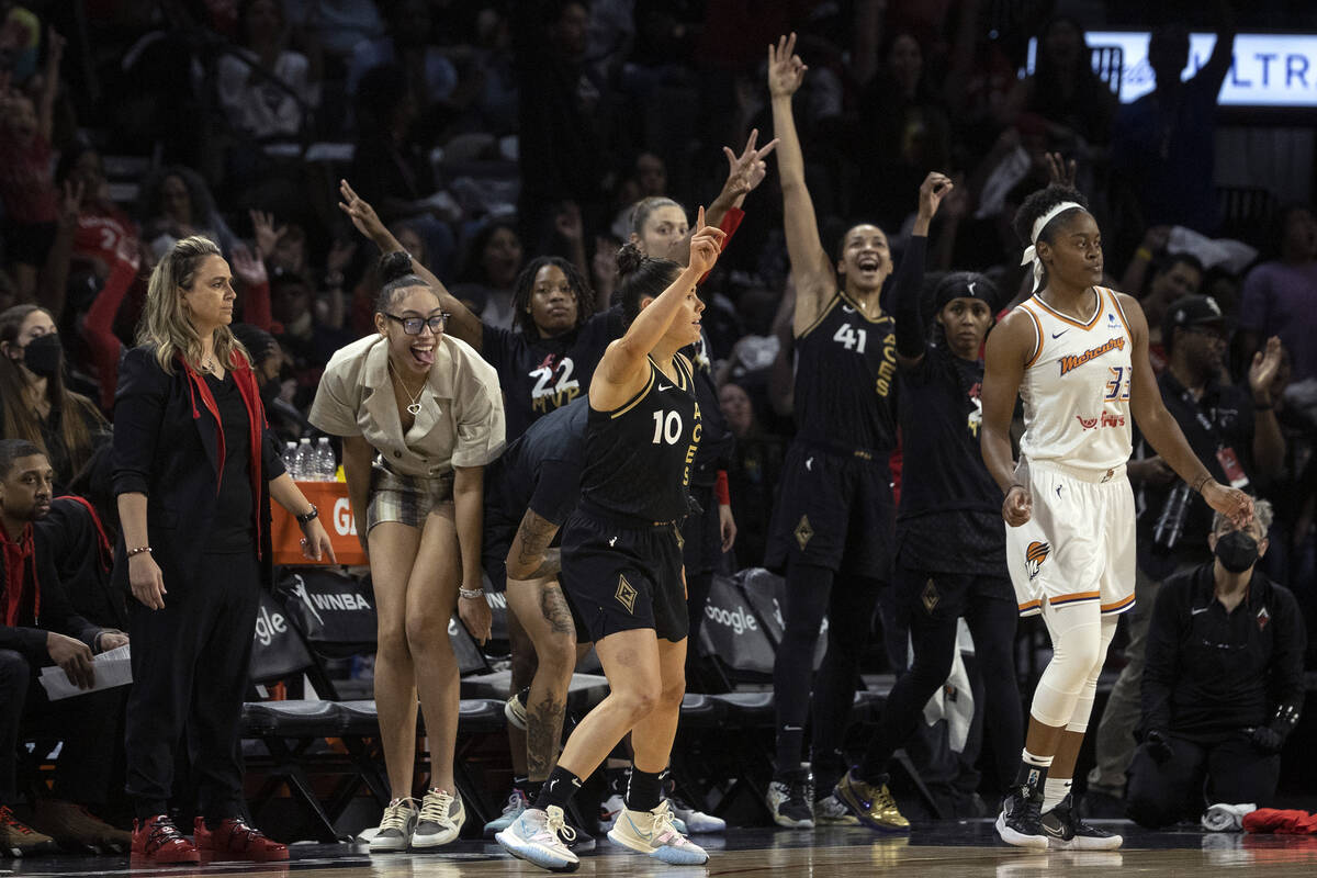 Las Vegas Aces guard Kelsey Plum (10) and the bench celebrate after Plum scored a 3-point shot ...
