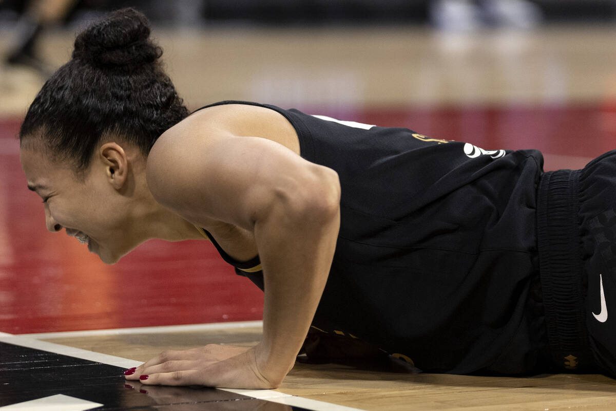 Las Vegas Aces center Kiah Stokes (41) falls to the court in pain during the second half of a W ...
