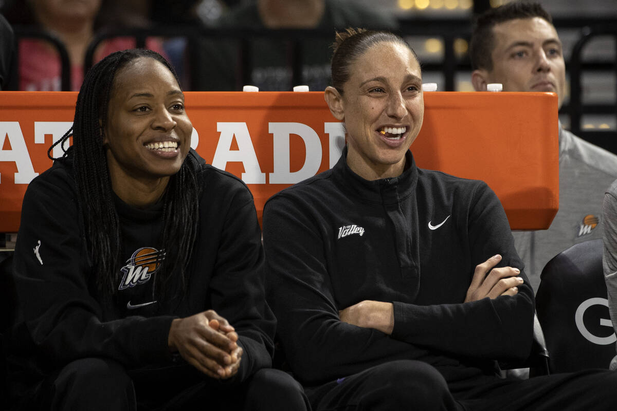 Phoenix Mercury guard Diana Taurasi, right, who is injured, laughs from the bench during the se ...