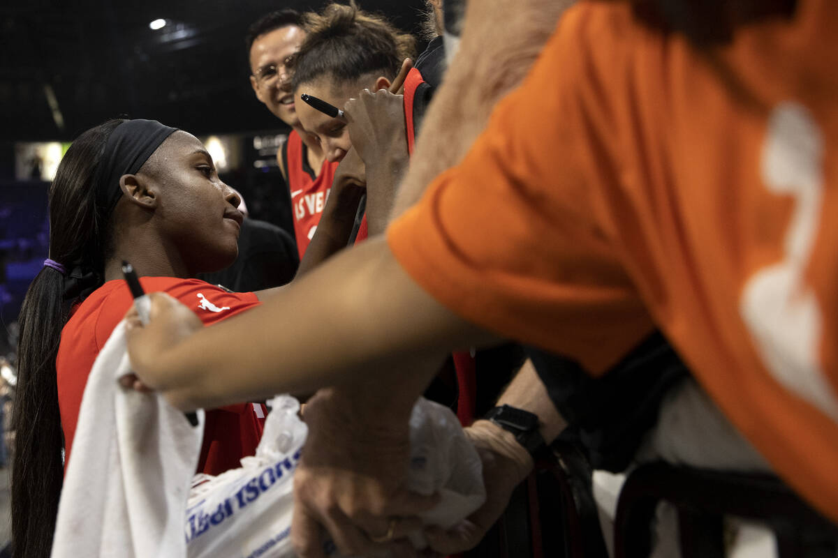 Las Vegas Aces guard Jackie Young signs autographs for fans after winning a WNBA playoff basket ...