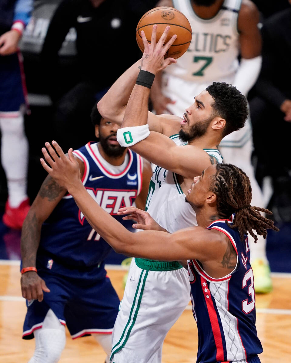 Boston Celtics forward Jayson Tatum (0) shoots against Brooklyn Nets forward Nic Claxton, right ...