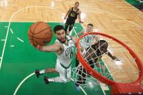 In this June 8, 2022, file photo, Boston Celtics forward Jayson Tatum (0) goes up for a shot ag ...