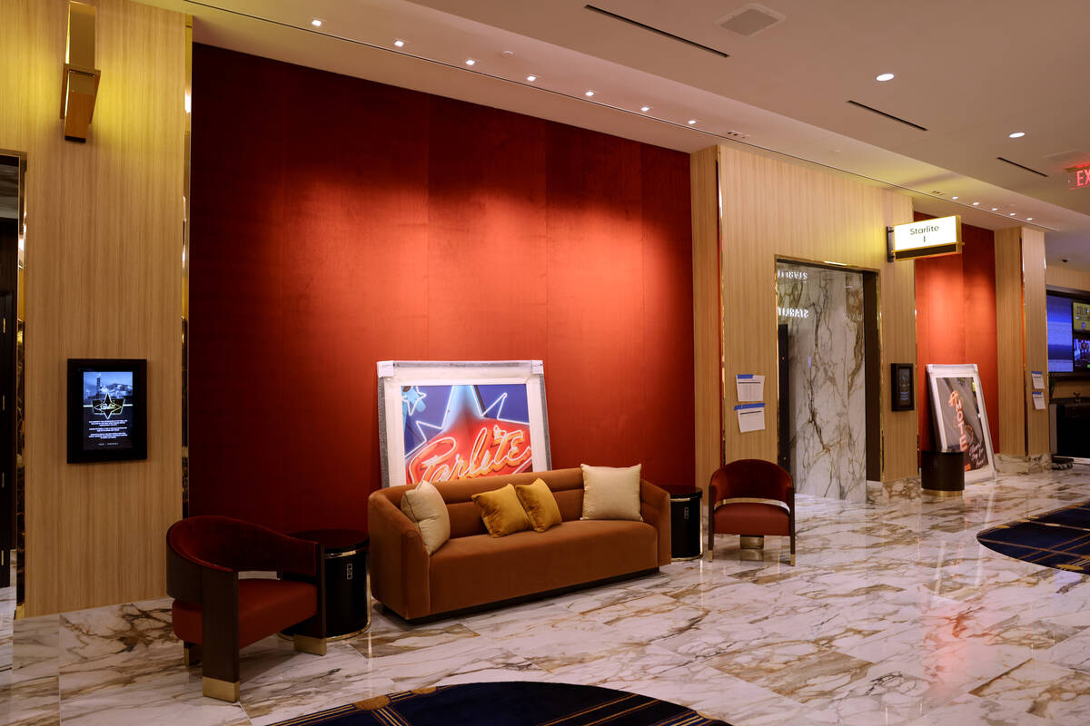 Workers put the finishing touches on the pre-function area at the new meetings and conventions ...