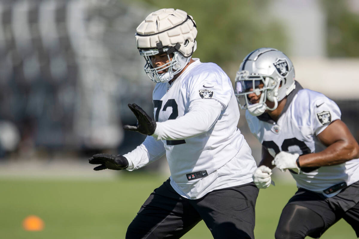 Raiders offensive lineman Jermaine Eluemunor (72) runs through reps during the team’s tr ...