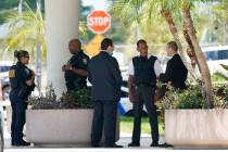 Law enforcement stands outside of the Paul G. Rogers Federal Courthouse, Thursday, Aug. 18, 202 ...