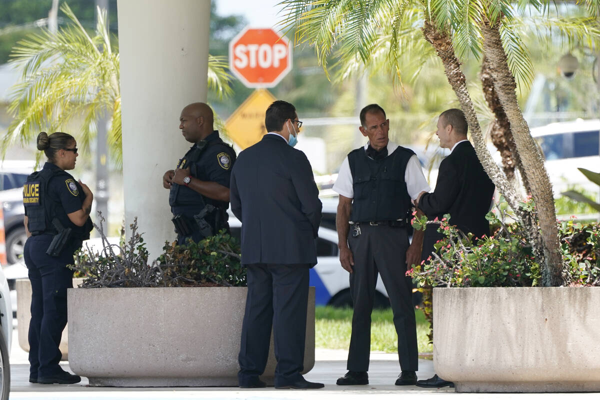 Law enforcement stands outside of the Paul G. Rogers Federal Courthouse, Thursday, Aug. 18, 202 ...
