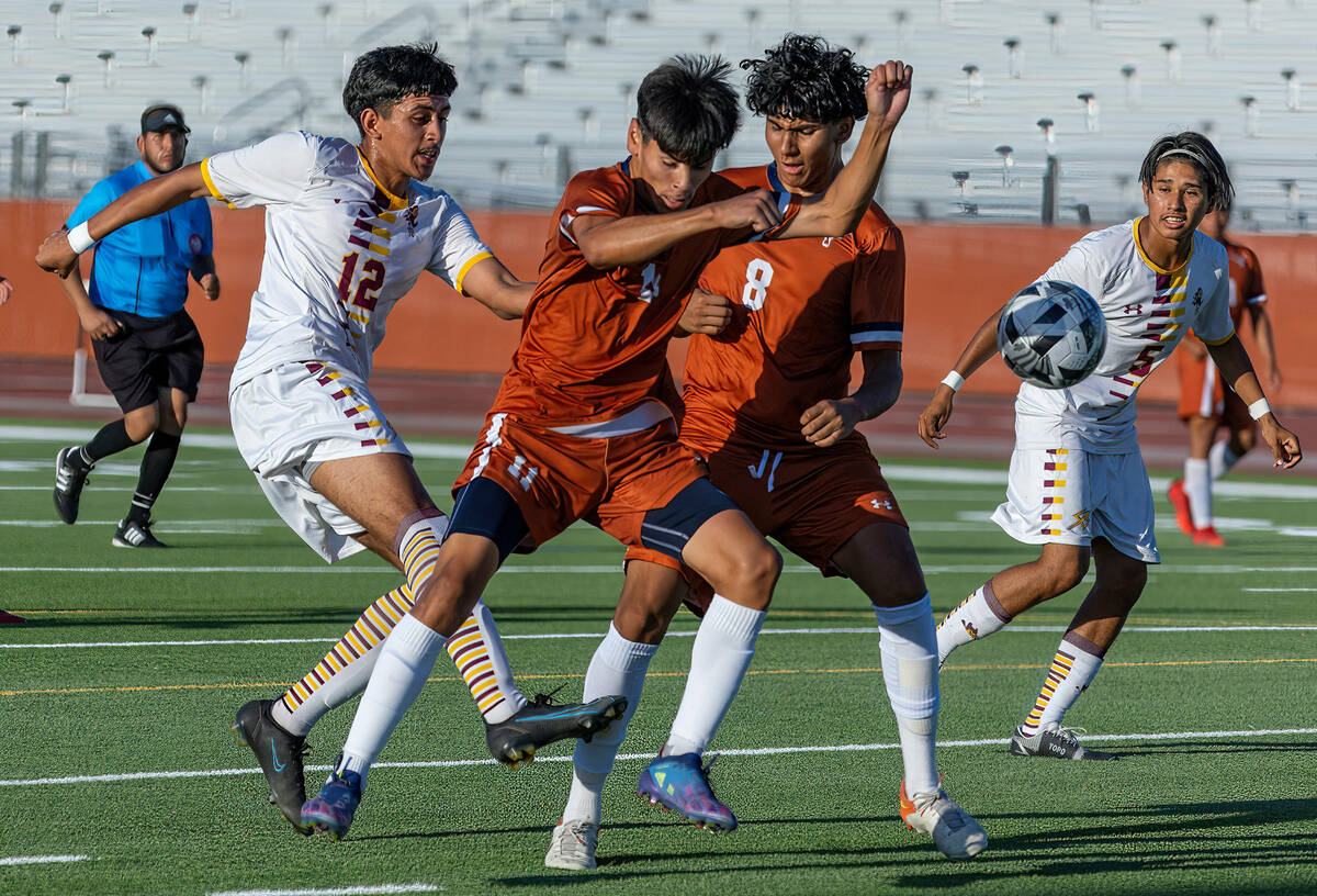 Eldorado striker David Figueroa (12) makes goal kick past Legacy forward Christian Nava (11) an ...
