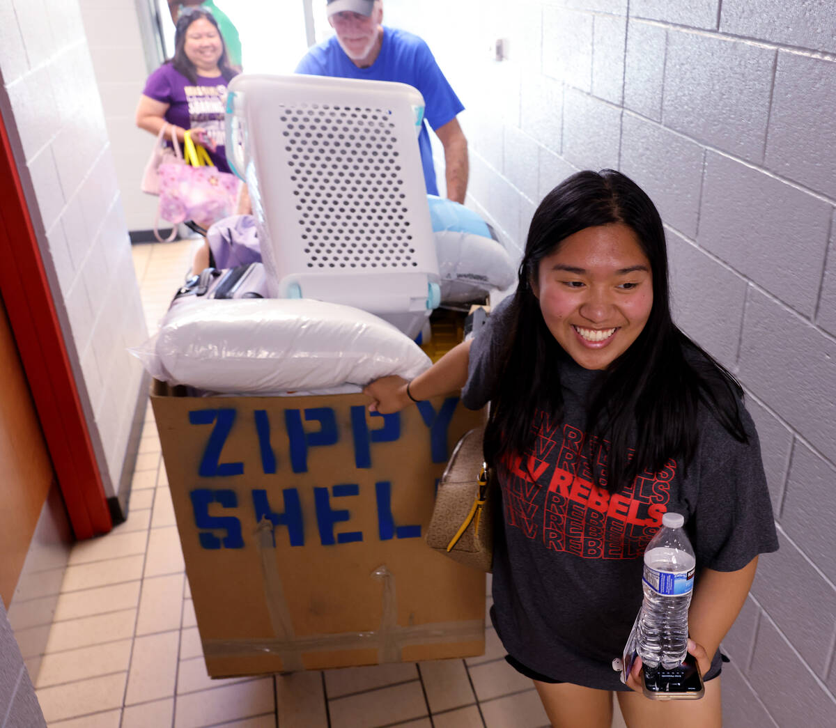 Student Antoinette Moreno rolls her possessions during dorm move-in day at UNLV Tuesday, Aug. 2 ...