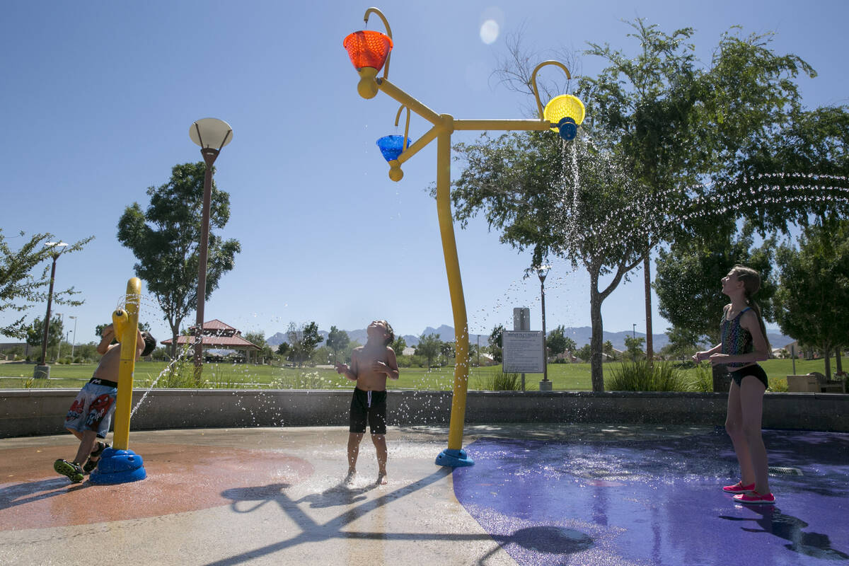 From left: Eric Taylor, 5, Matt Perkins, 6, and Abigail Hoguin, 11, all from North Las Vegas, p ...