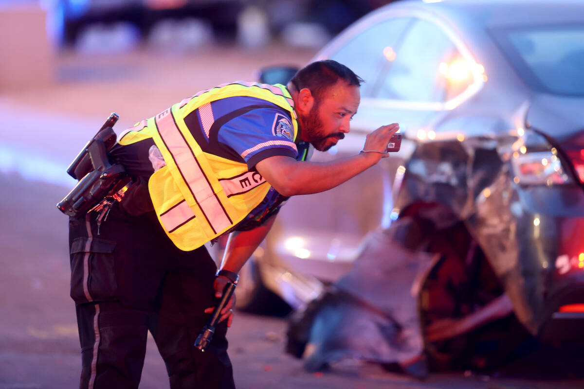 North Las Vegas Police Officer Andy Navarro, a fatal traffic investigator, snaps photos of evid ...