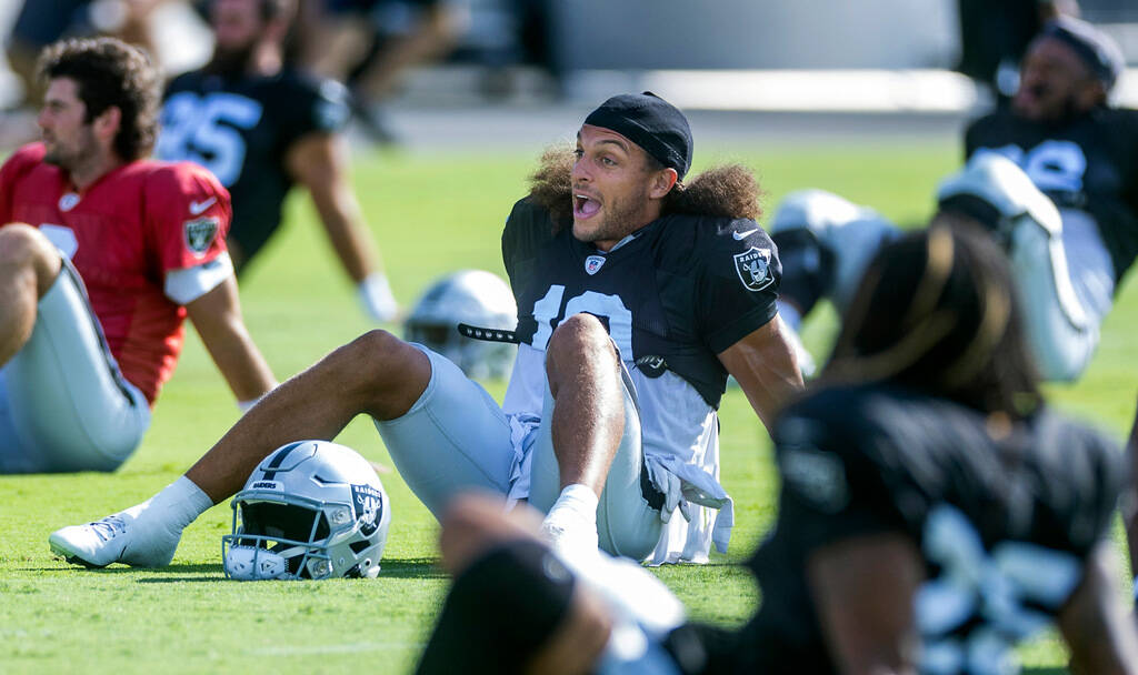 Raiders wide receiver Mack Hollins (10) talks while stretching during practice at the Intermoun ...