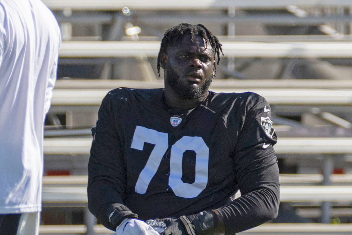 Raiders offensive tackle Alex Leatherwood (70) stretches during the team’s training camp ...