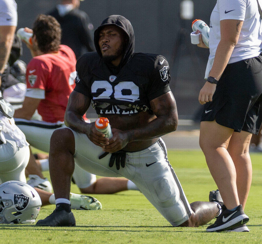 Raiders running back Josh Jacobs (28) stretches during the team’s training camp practice ...
