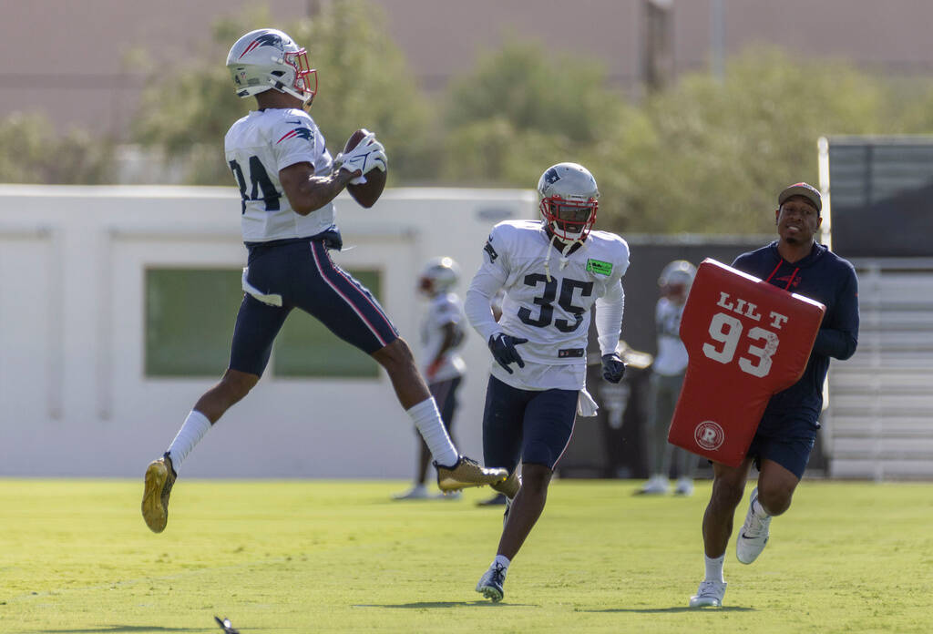 New England Patriots cornerback Jack Jones (34) leaps to make a play with safety Brad Hawkins ( ...
