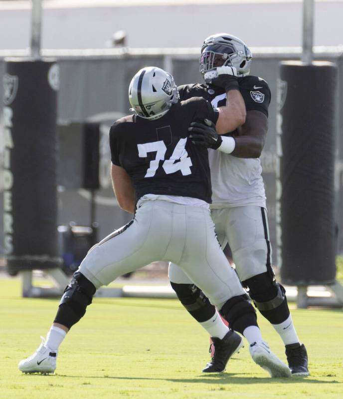 Raiders offensive tackle Kolton Miller (74) pressures offensive tackle Bamidele Olaseni (79) du ...